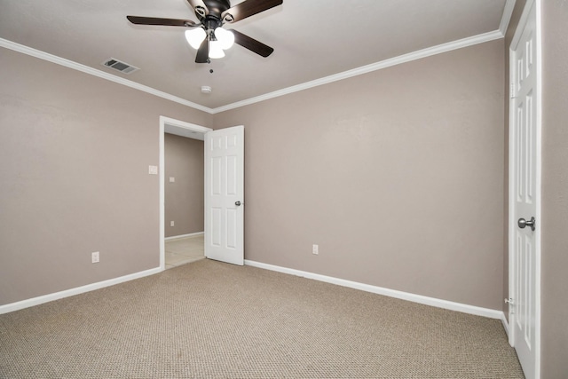 unfurnished bedroom with ceiling fan, carpet, and crown molding