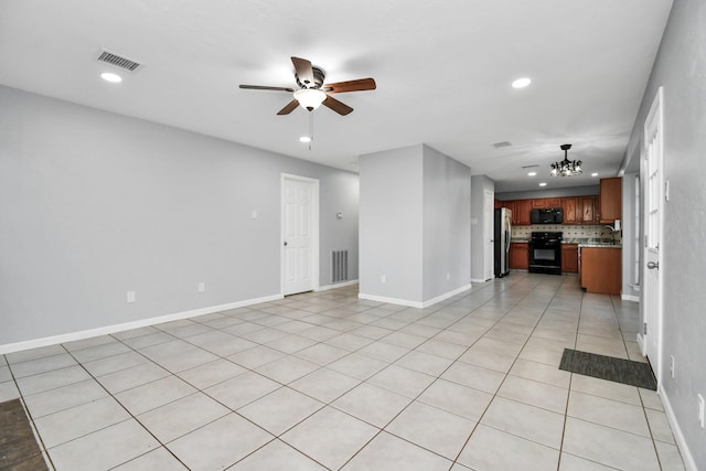 unfurnished living room with sink, ceiling fan with notable chandelier, and light tile patterned floors