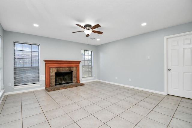 unfurnished living room with ceiling fan, a fireplace, and light tile patterned flooring