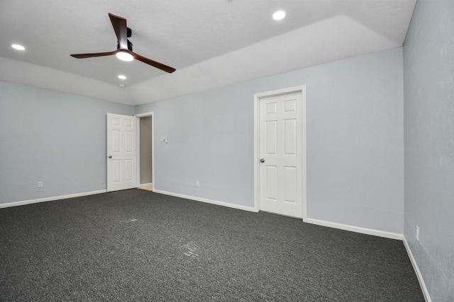 carpeted spare room featuring ceiling fan