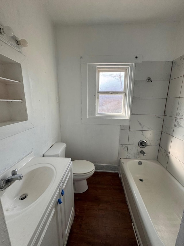 bathroom featuring hardwood / wood-style floors, vanity, toilet, and a bath