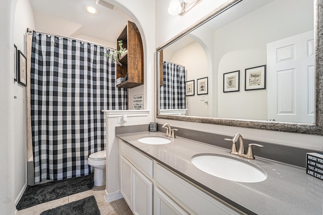 bathroom featuring tile patterned floors, toilet, and vanity