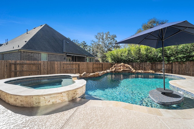 view of swimming pool with an in ground hot tub