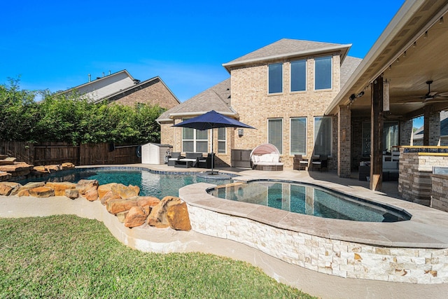 view of pool featuring an in ground hot tub, ceiling fan, an outdoor fire pit, and a patio