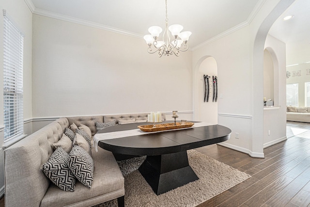 dining area featuring crown molding, dark hardwood / wood-style floors, a notable chandelier, and breakfast area