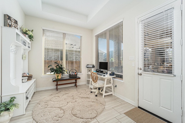 office space featuring a tray ceiling