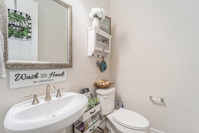 bathroom with toilet and sink