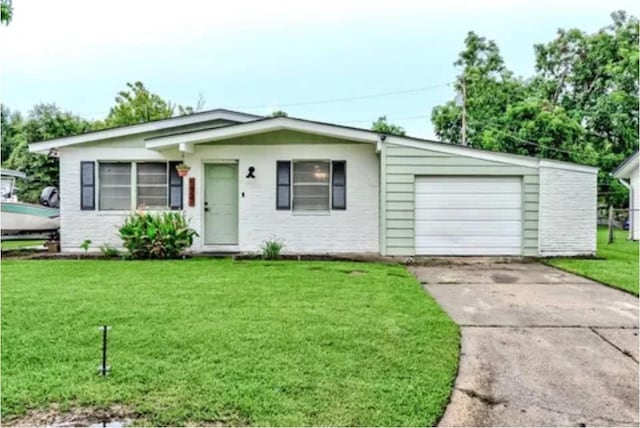 view of front of property with a garage and a front lawn