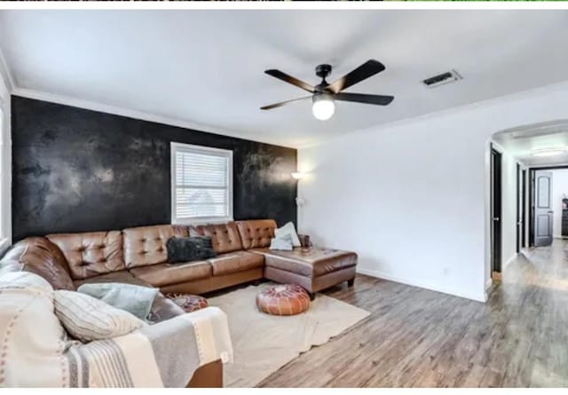 living room with ceiling fan, hardwood / wood-style floors, and crown molding