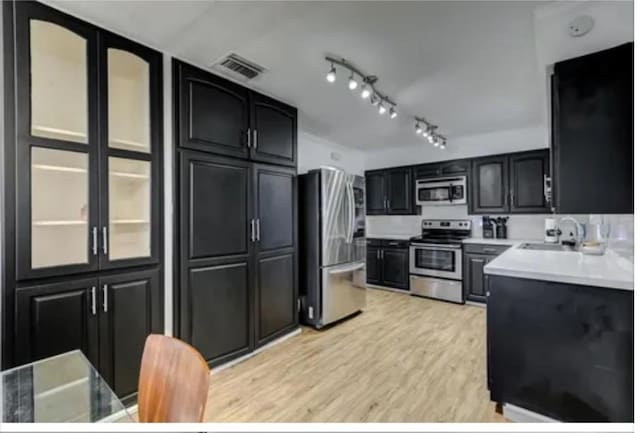 kitchen featuring light hardwood / wood-style floors, sink, and stainless steel appliances