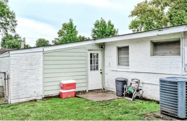 exterior space featuring a yard and cooling unit