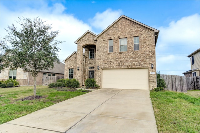 view of front of property with a front yard and a garage