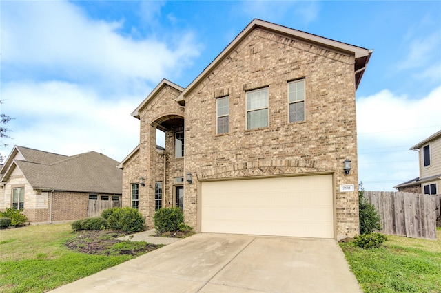 view of front of property featuring a garage and a front lawn