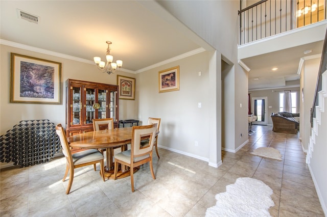 dining space featuring light tile patterned floors, crown molding, and a chandelier