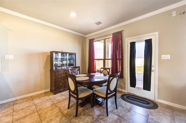 dining space with light tile patterned floors and ornamental molding