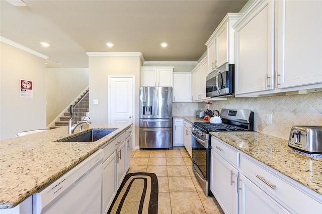 kitchen with white cabinetry, sink, light tile patterned floors, and stainless steel appliances