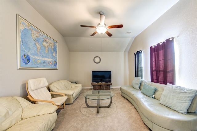 carpeted living room featuring ceiling fan and vaulted ceiling