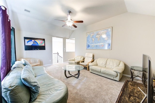 living room featuring ceiling fan, carpet floors, and vaulted ceiling