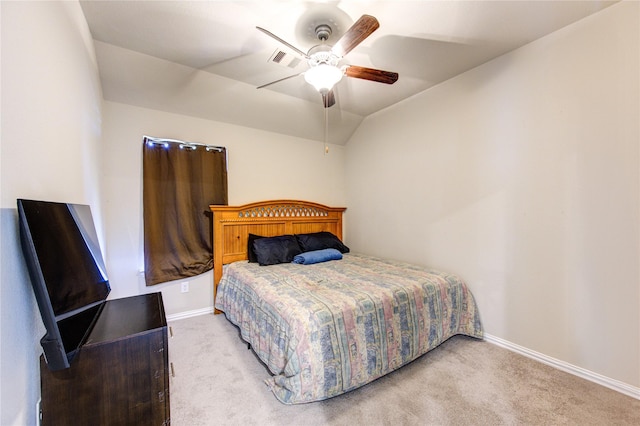 carpeted bedroom with ceiling fan and vaulted ceiling