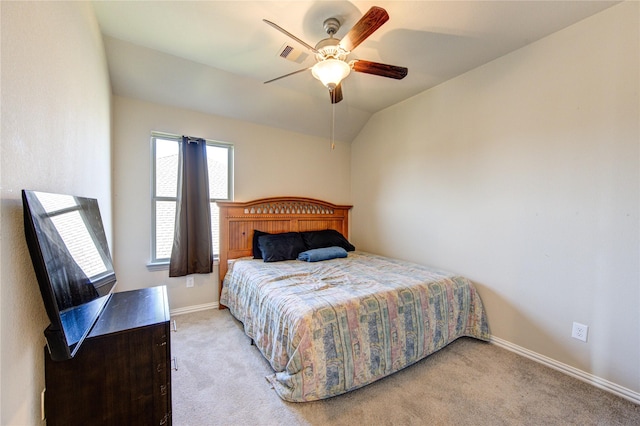 carpeted bedroom with ceiling fan and vaulted ceiling