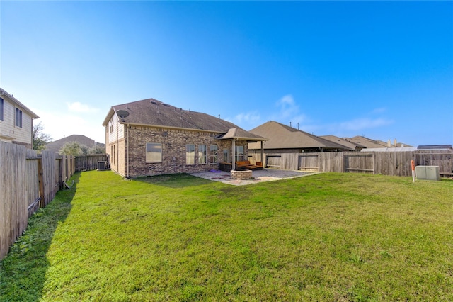 back of house featuring a yard, a patio, and central air condition unit