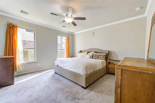 carpeted bedroom with ceiling fan and crown molding