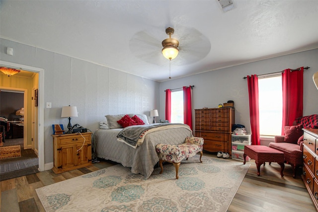 bedroom featuring ceiling fan and light hardwood / wood-style floors