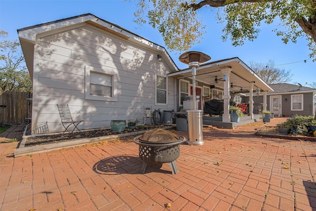 back of house featuring a fire pit, ceiling fan, and a patio area