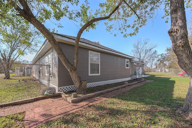 view of property exterior featuring a lawn