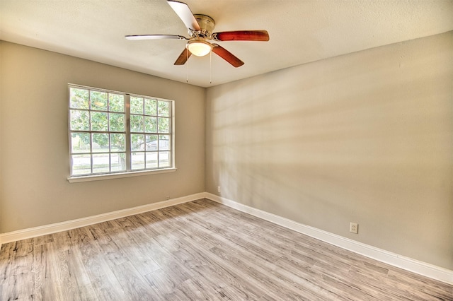 spare room with ceiling fan and light hardwood / wood-style floors