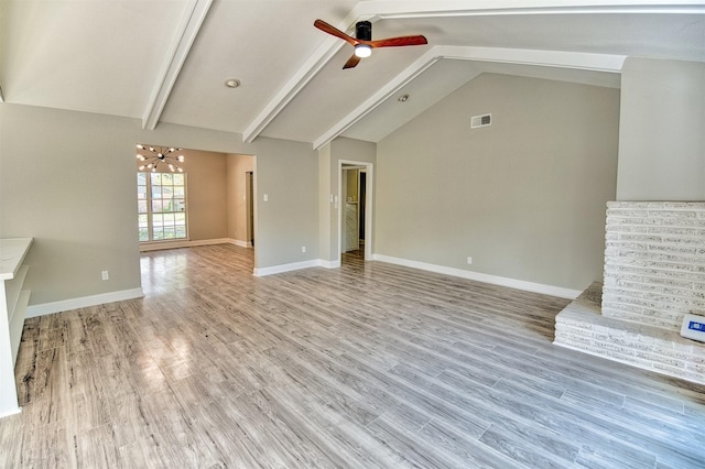 unfurnished living room featuring vaulted ceiling with beams, light hardwood / wood-style floors, and ceiling fan with notable chandelier