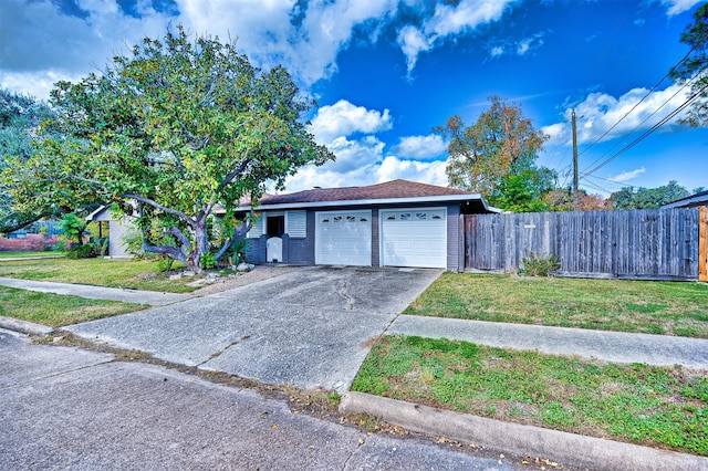 view of front of home with a garage and a front lawn