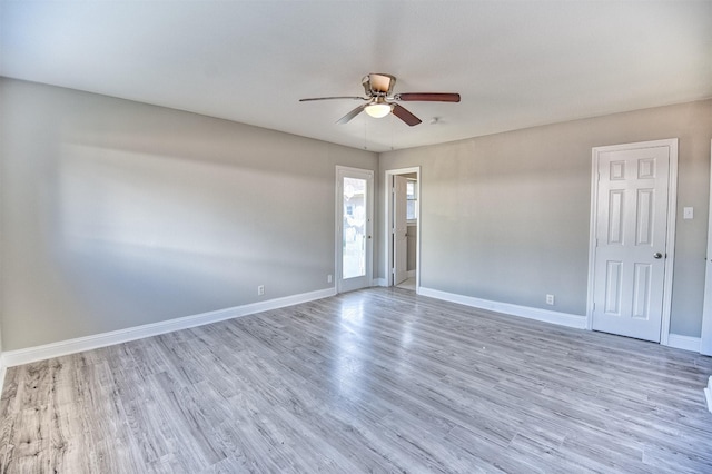 empty room with ceiling fan and wood-type flooring