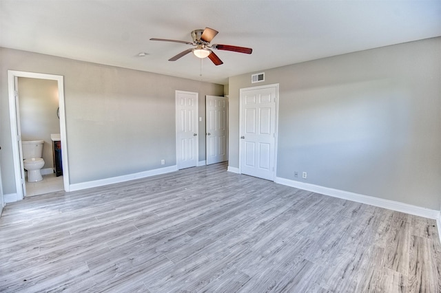 unfurnished bedroom featuring ensuite bathroom, ceiling fan, and light hardwood / wood-style floors