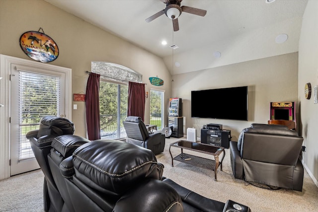 carpeted living room featuring ceiling fan, a wealth of natural light, and lofted ceiling