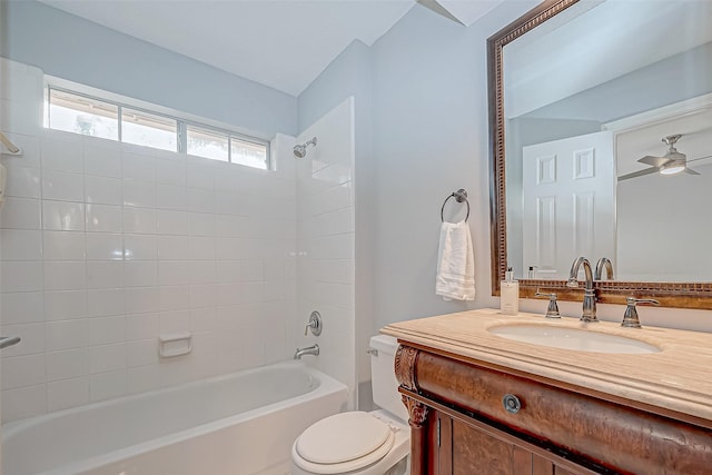 full bathroom with toilet, ceiling fan, tiled shower / bath combo, and vanity