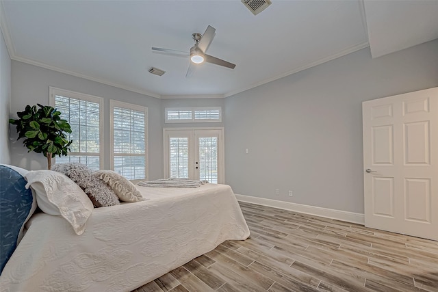 bedroom featuring ceiling fan, access to exterior, hardwood / wood-style floors, crown molding, and french doors