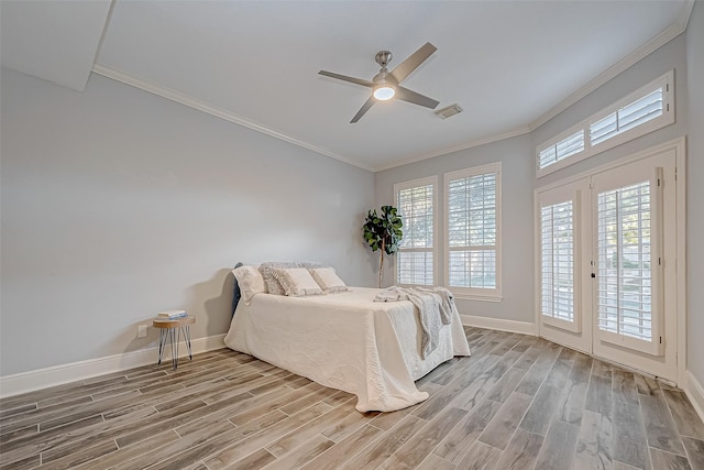 bedroom featuring ceiling fan, access to exterior, multiple windows, and wood-type flooring