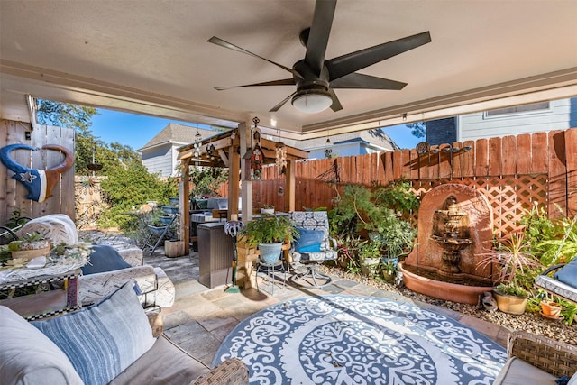 view of patio with outdoor lounge area and ceiling fan