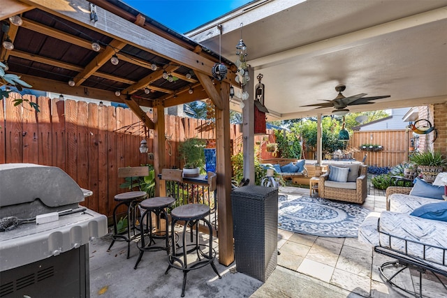 view of patio featuring an outdoor living space, ceiling fan, and grilling area