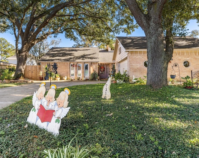 view of front facade with a garage and a front lawn