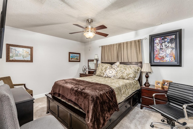 bedroom with a textured ceiling, light colored carpet, and ceiling fan