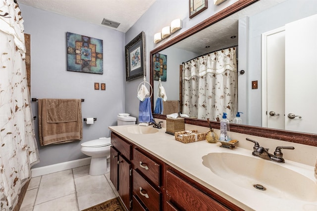 bathroom featuring tile patterned floors, vanity, toilet, and a textured ceiling