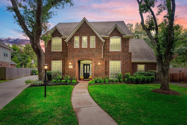 view of front of house featuring french doors and a yard