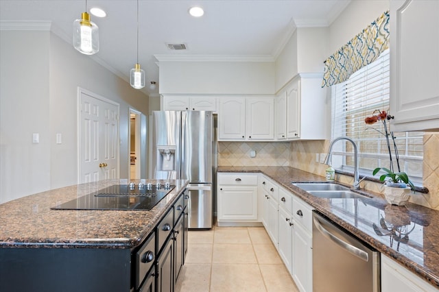 kitchen with white cabinetry, sink, dark stone counters, and appliances with stainless steel finishes