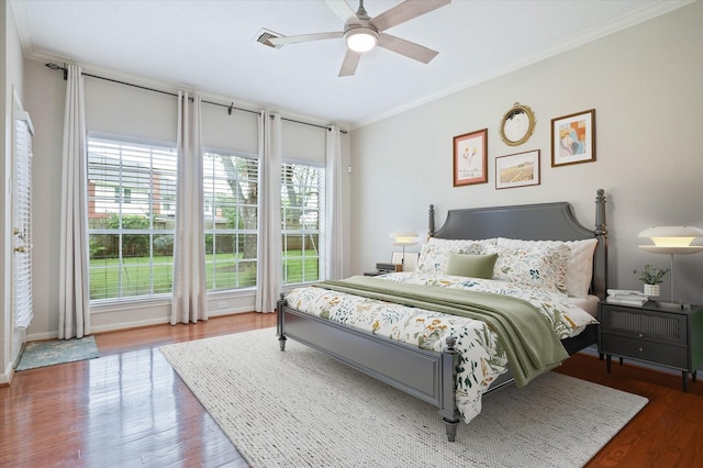 bedroom with ceiling fan, crown molding, and hardwood / wood-style flooring