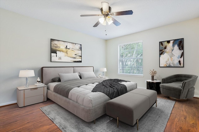 bedroom featuring ceiling fan and dark wood-type flooring