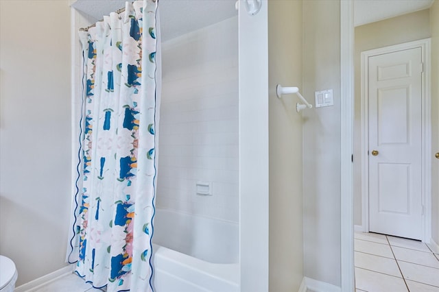 bathroom with tile patterned floors, toilet, and shower / tub combo