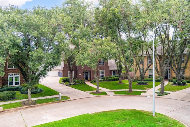 view of front of house featuring a garage and a front lawn