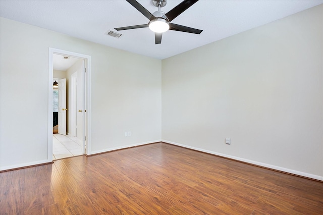 spare room featuring ceiling fan and light hardwood / wood-style flooring